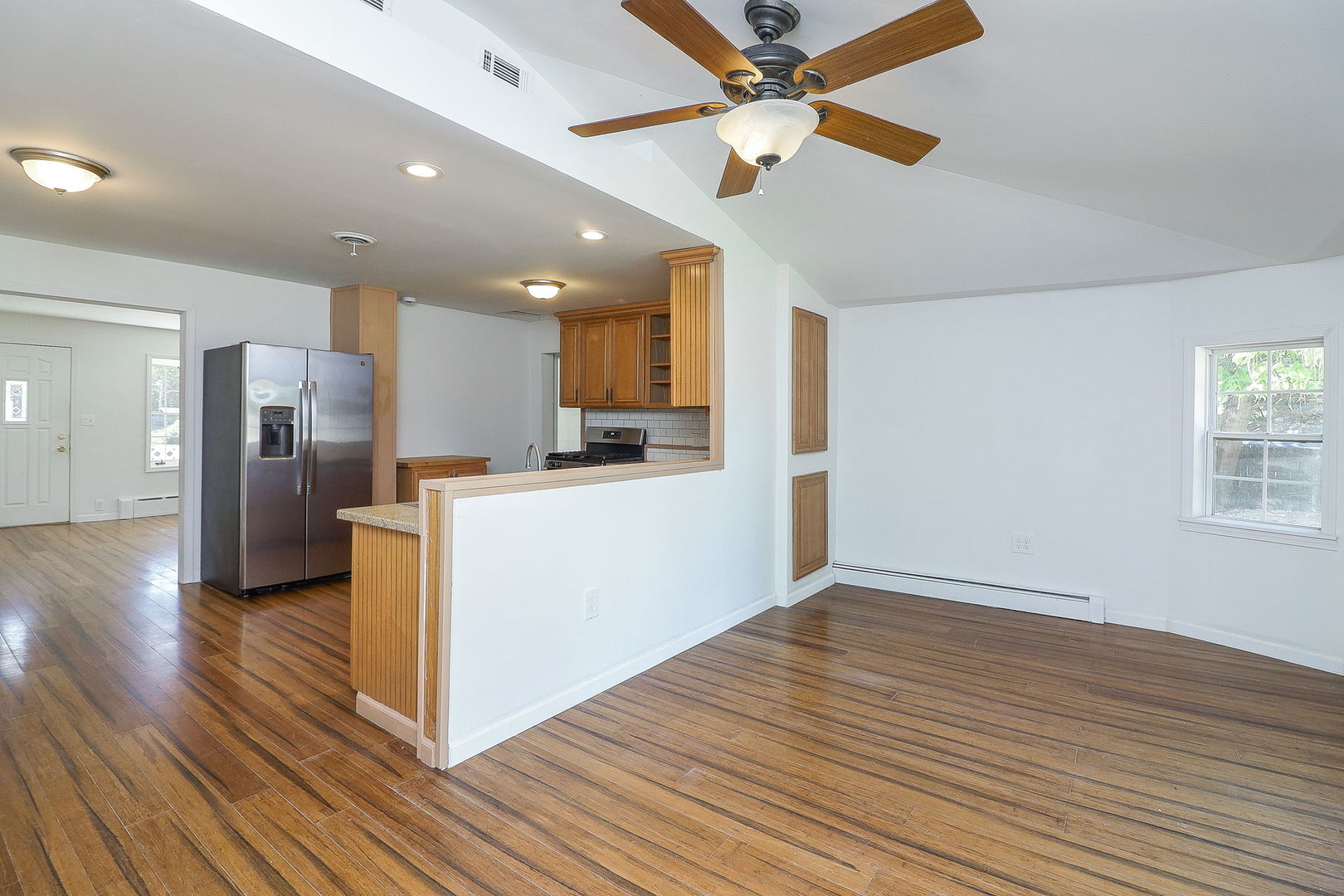 513 Conant Avenue Joliet, IL 60435 - Photo 11 of 30 a view of a kitchen with a refrigerator a ceiling fan and wooden floor