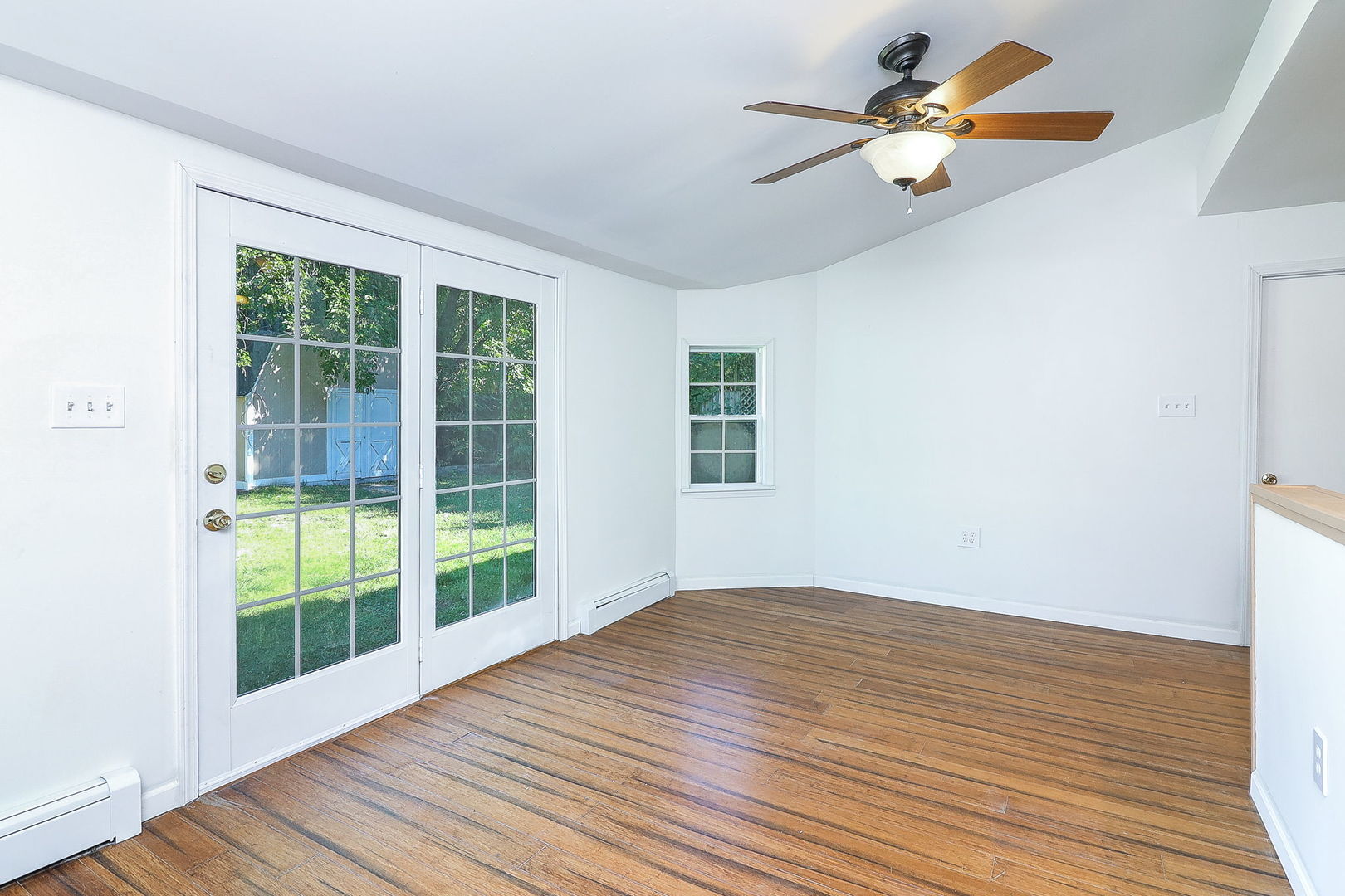 513 Conant Avenue Joliet, IL 60435 - Photo 14 of 30 a view of an empty room with wooden floor and a window