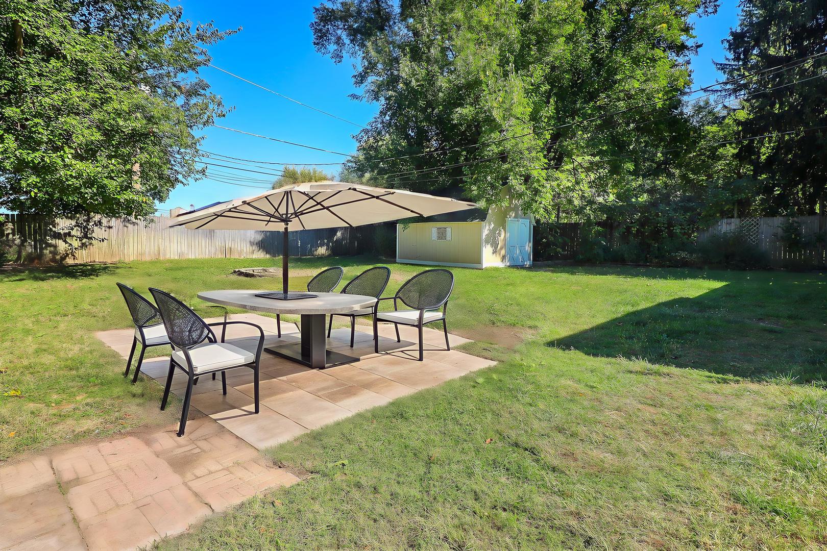 513 Conant Avenue Joliet, IL 60435 - Photo 23 of 30 a view of a table and chairs under an umbrella