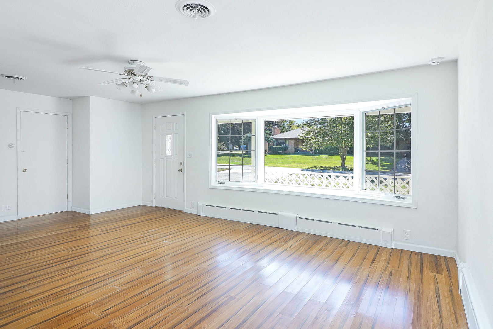513 Conant Avenue Joliet, IL 60435 - Photo 5 of 30 a view of an empty room with wooden floor and a window