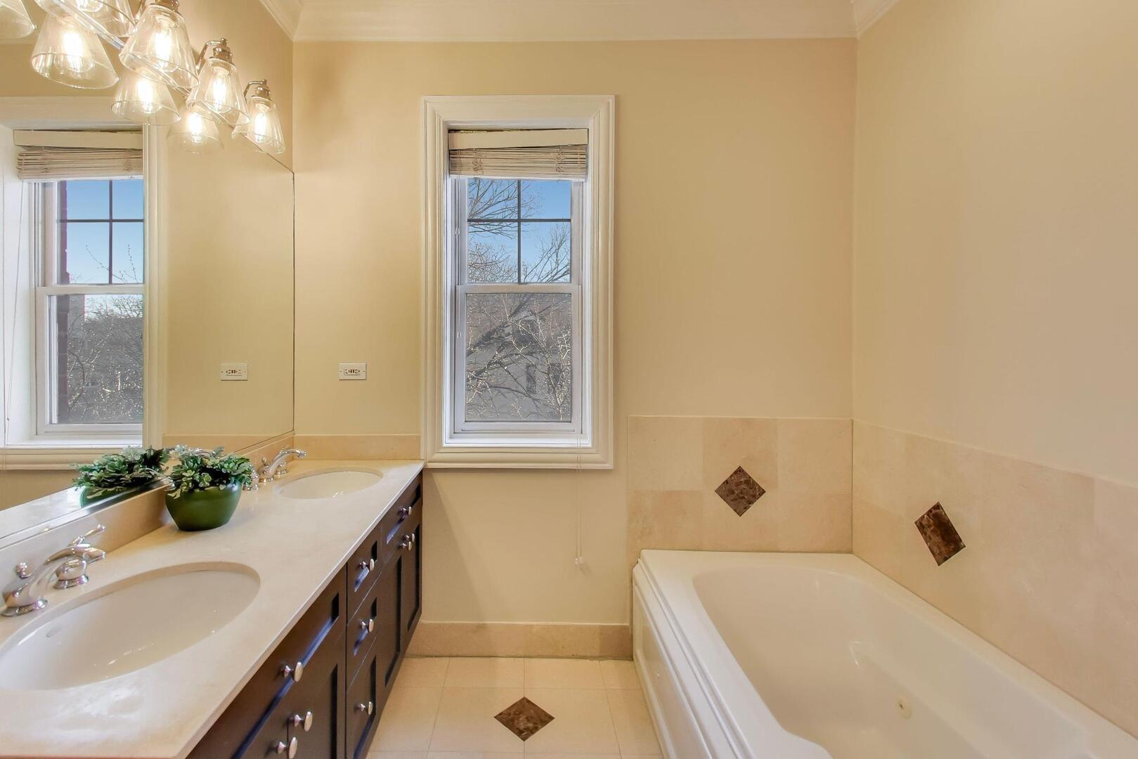 1400 West George Street, Unit 3 Chicago, IL 60657 - Photo 19 of 46 a bathroom with a tub sink and mirror
