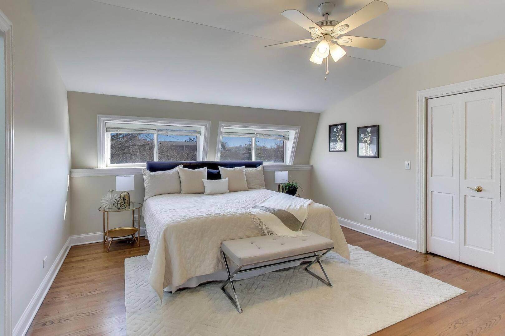 1400 West George Street, Unit 3 Chicago, IL 60657 - Photo 30 of 46 a spacious bedroom with a bed and a chandelier