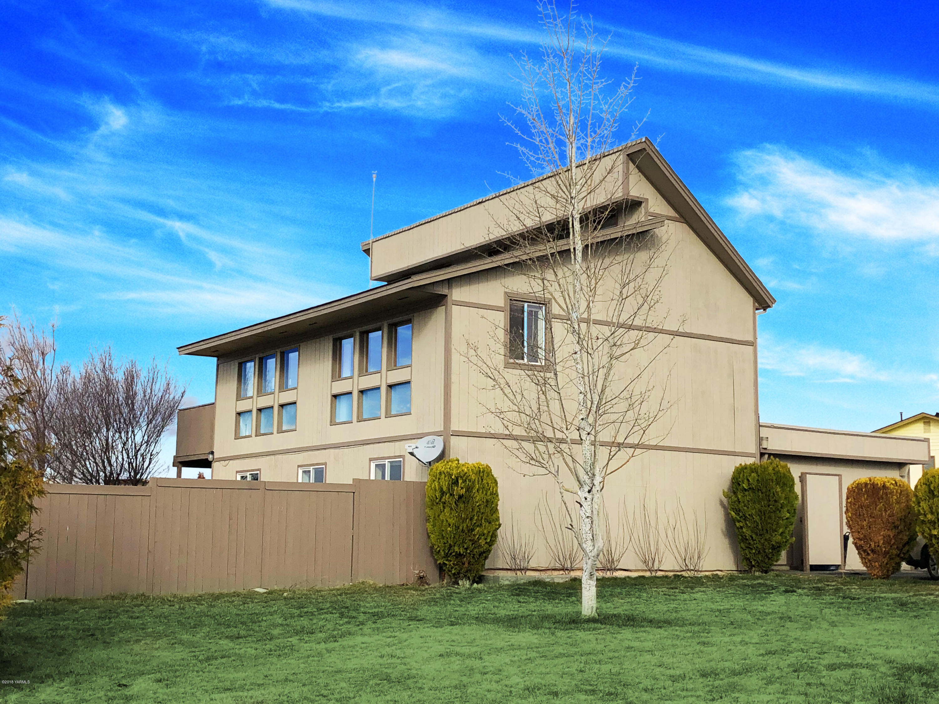 a view of wooden house with a yard
