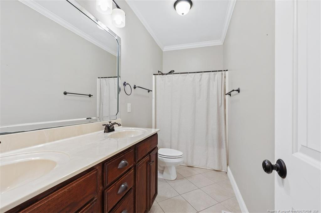 704 Micahs Way North Spring Lake, NC 28390 - Photo 28 of 43 a bathroom with a sink a toilet and a mirror