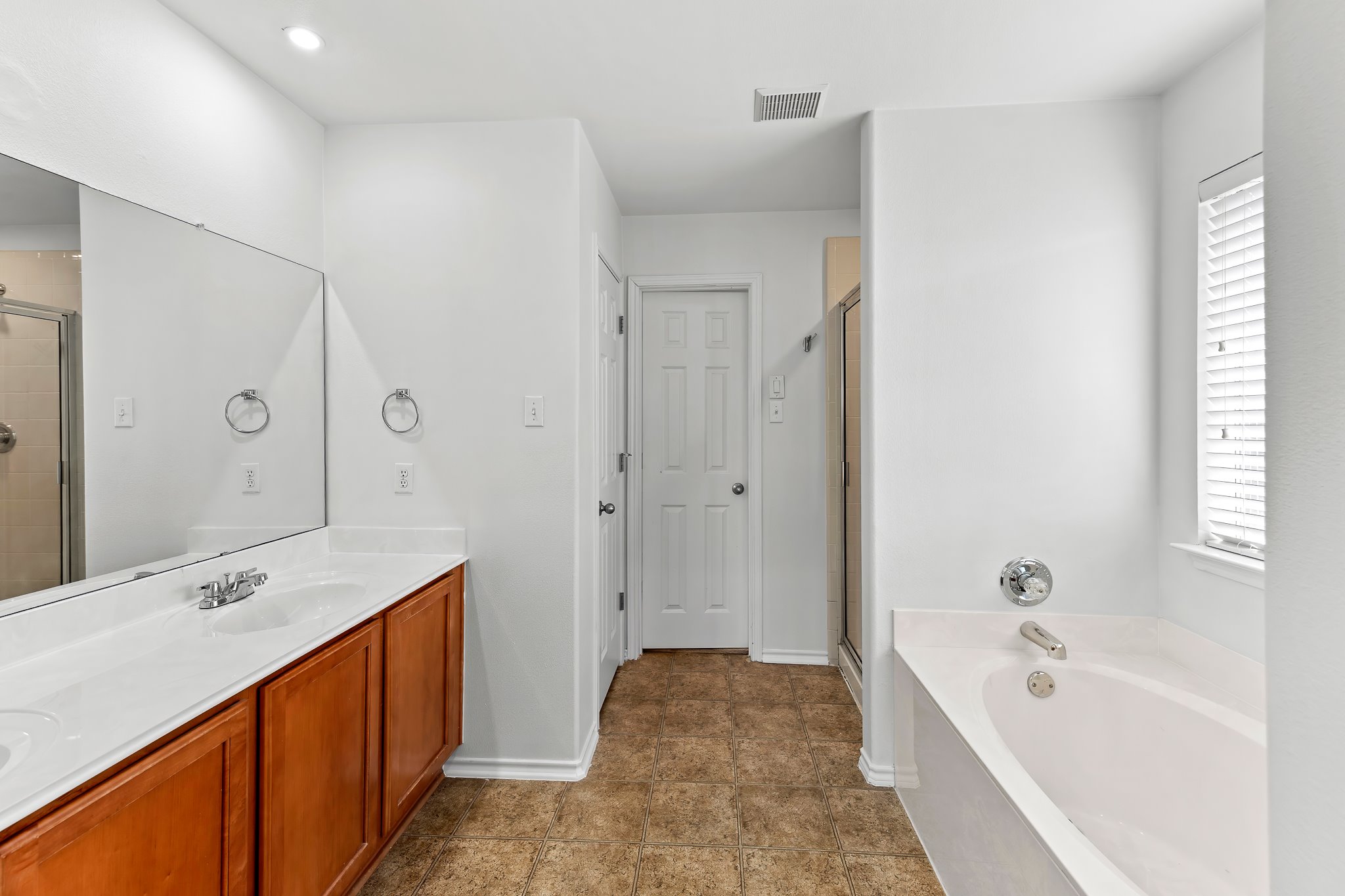 6700 Tulloch Way Austin, TX 78754 - Photo 27 of 39 a spacious bathroom with a tub sink and mirror