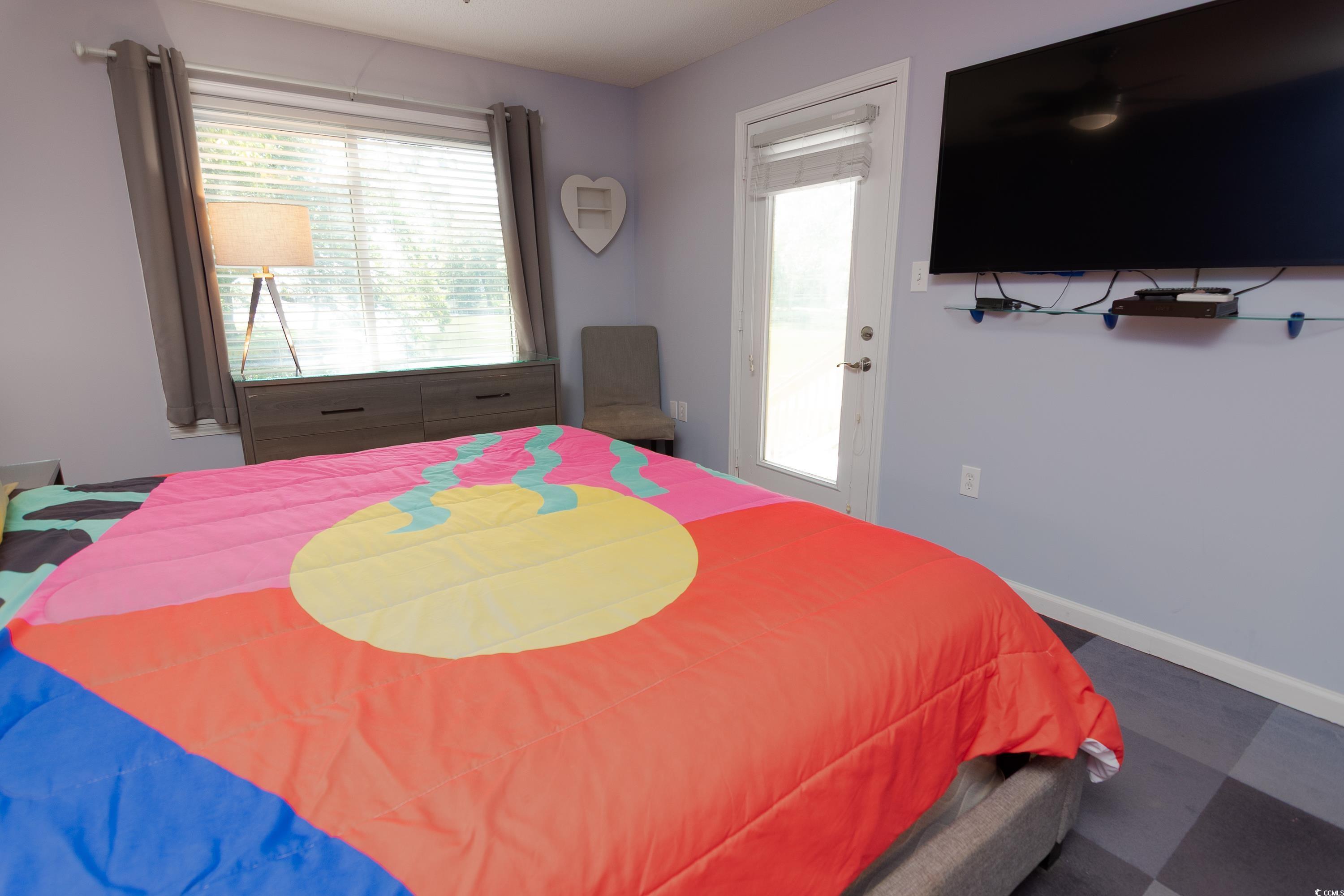 211 Baslow Court, Unit 2C Myrtle Beach, SC 29572 - Photo 21 of 33 Bedroom featuring baseboards and access to outside