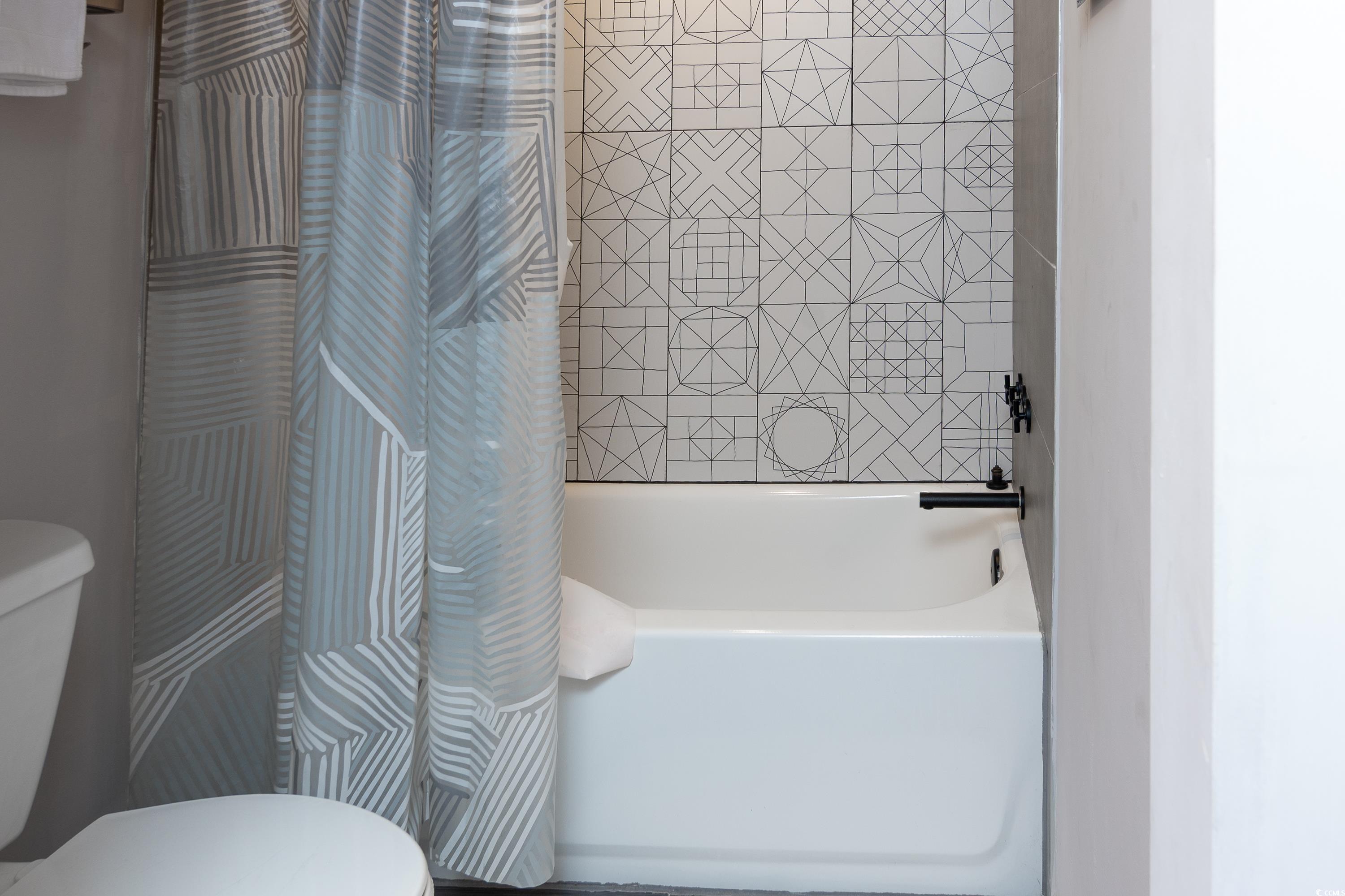 211 Baslow Court, Unit 2C Myrtle Beach, SC 29572 - Photo 6 of 33 Bathroom with toilet and shower / bathtub combination with curtain