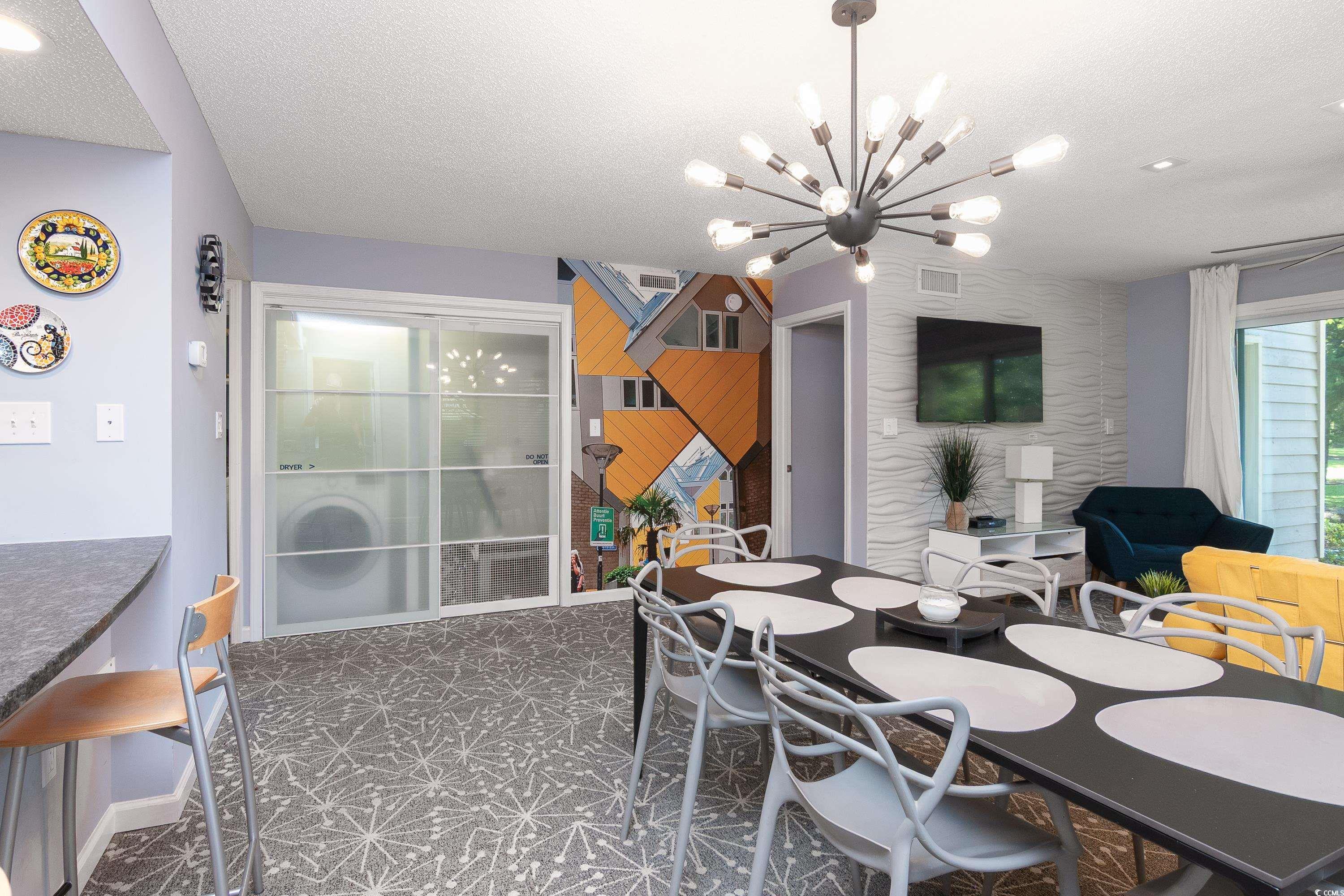 211 Baslow Court, Unit 2C Myrtle Beach, SC 29572 - Photo 10 of 33 Dining space featuring a textured ceiling, dark carpet, a chandelier, and recessed lighting