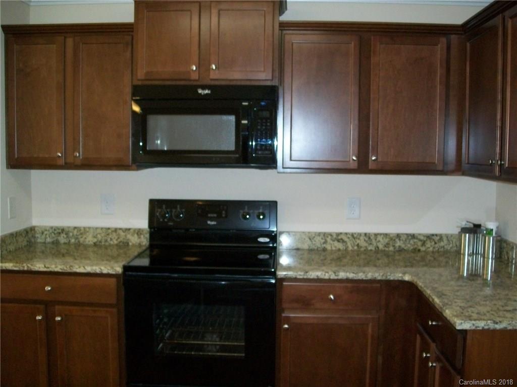 563 Kelly Road, Unit 2 York, SC 29745 - Photo 11 of 19 a kitchen with granite countertop stainless steel appliances and cabinets