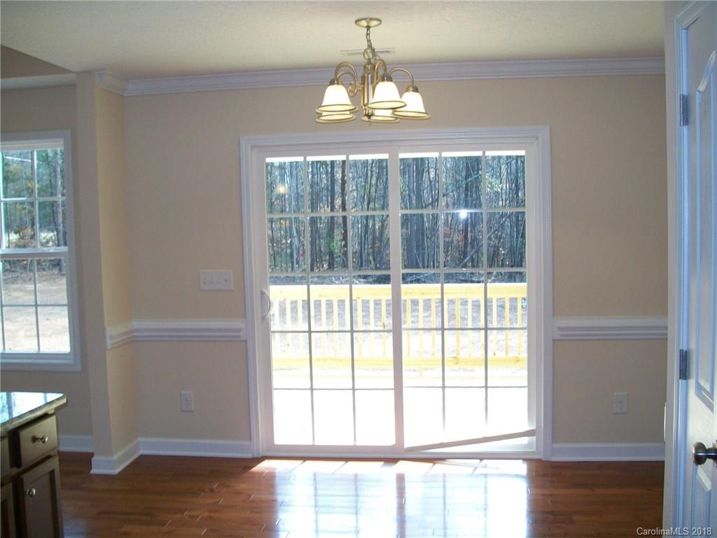 563 Kelly Road, Unit 2 York, SC 29745 - Photo 16 of 19 a view of an empty room with wooden floor and a window