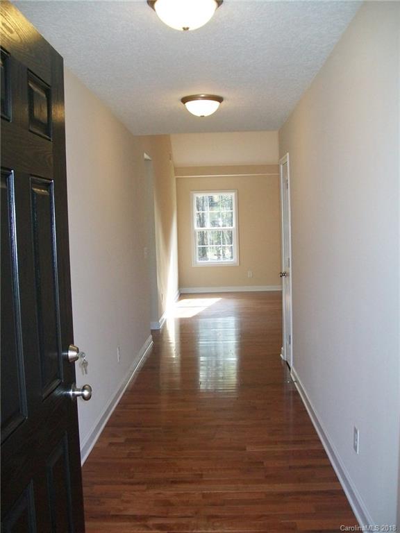 563 Kelly Road, Unit 2 York, SC 29745 - Photo 6 of 19 a view of an empty room with wooden floor and a window