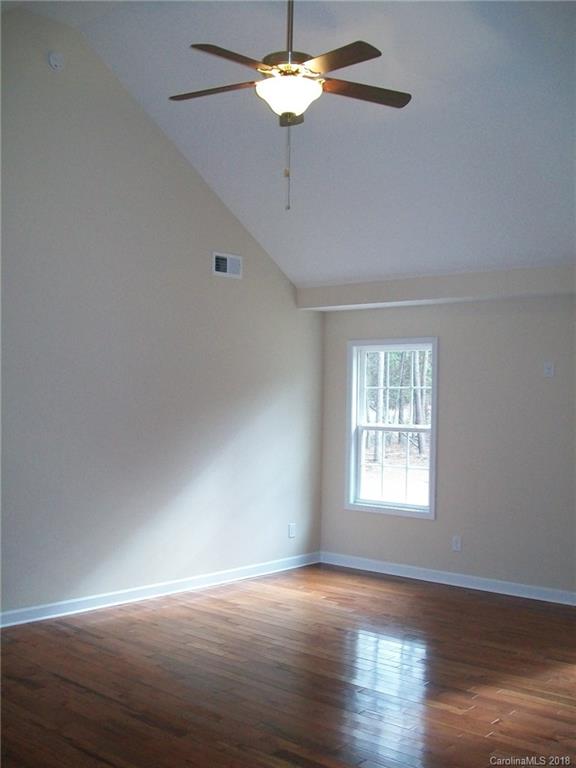 563 Kelly Road, Unit 2 York, SC 29745 - Photo 8 of 19 a view of an empty room with wooden floor and a window
