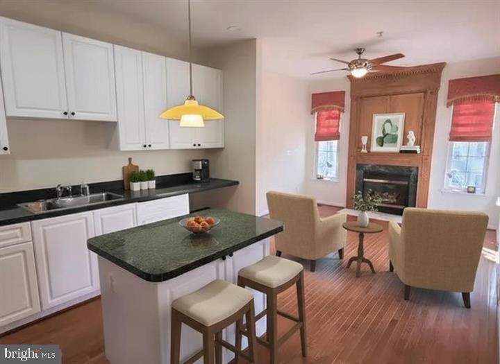 164 Tilden Way, Unit 164 Edgewater, MD 21037 - Photo 6 of 24 a kitchen with a table chairs refrigerator and cabinets