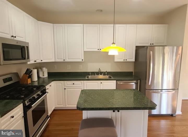 164 Tilden Way, Unit 164 Edgewater, MD 21037 - Photo 8 of 24 a kitchen with kitchen island granite countertop stainless steel appliances a stove a refrigerator a sink a counter space and cabinets