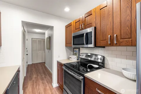 a kitchen with a stove microwave and sink