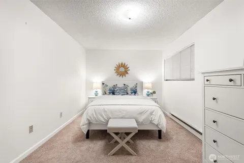 a bedroom with a bed and a table