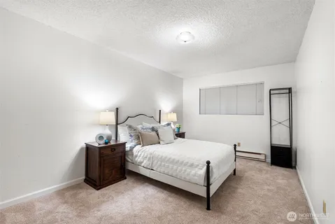 a bedroom with double bed and a night stand