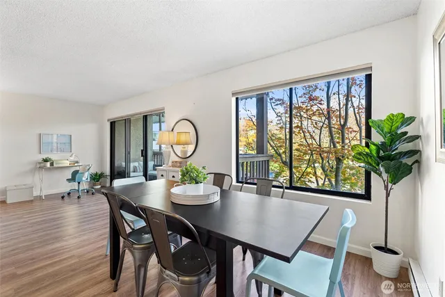 a view of a dining room with furniture window and wooden floor
