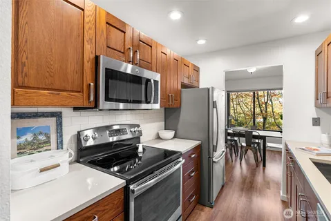 a kitchen with a stove a sink and a microwave