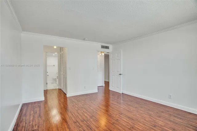 a view of wooden floor and windows in a room