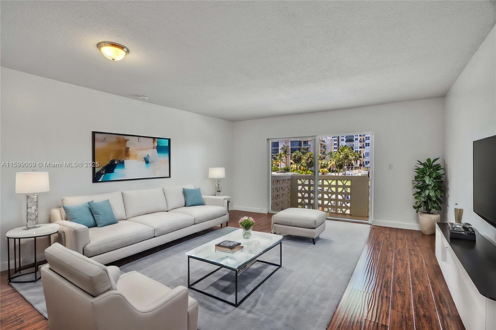 1901 South Ocean Drive, Unit 207 Hollywood, FL 33019 - Photo 2 of 47 a living room with furniture and a wooden floor