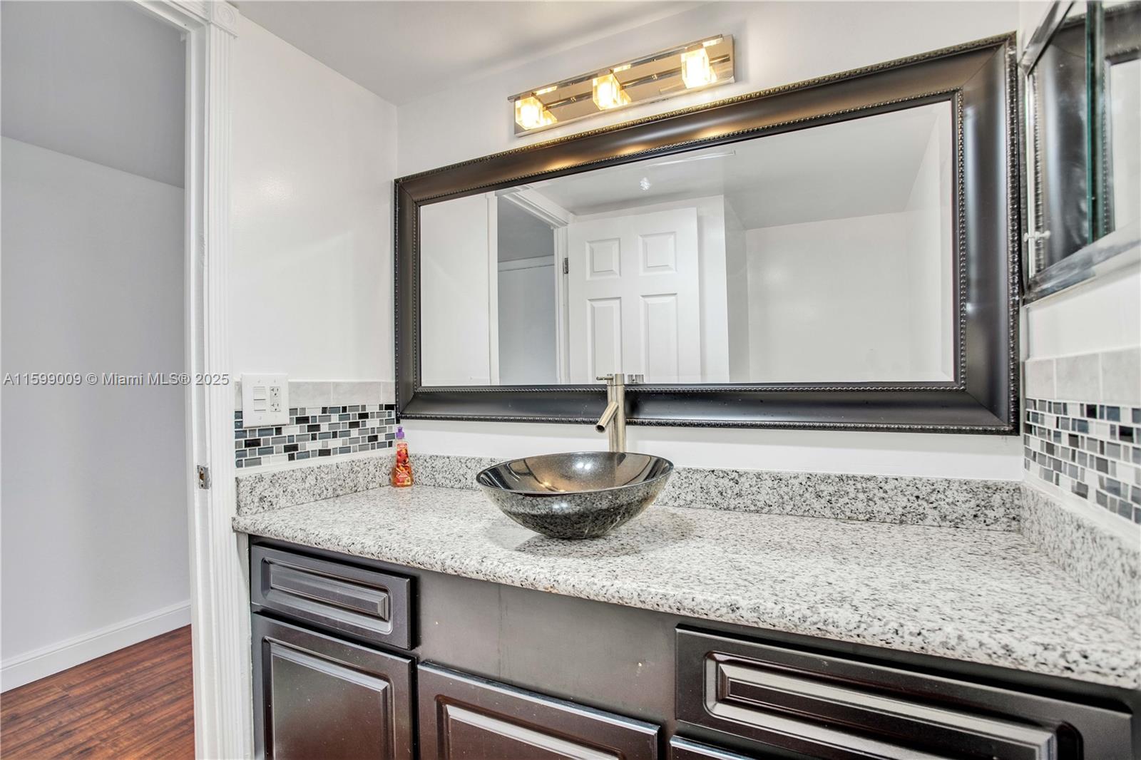 1901 South Ocean Drive, Unit 207 Hollywood, FL 33019 - Photo 24 of 47 a bathroom with a sink and mirror