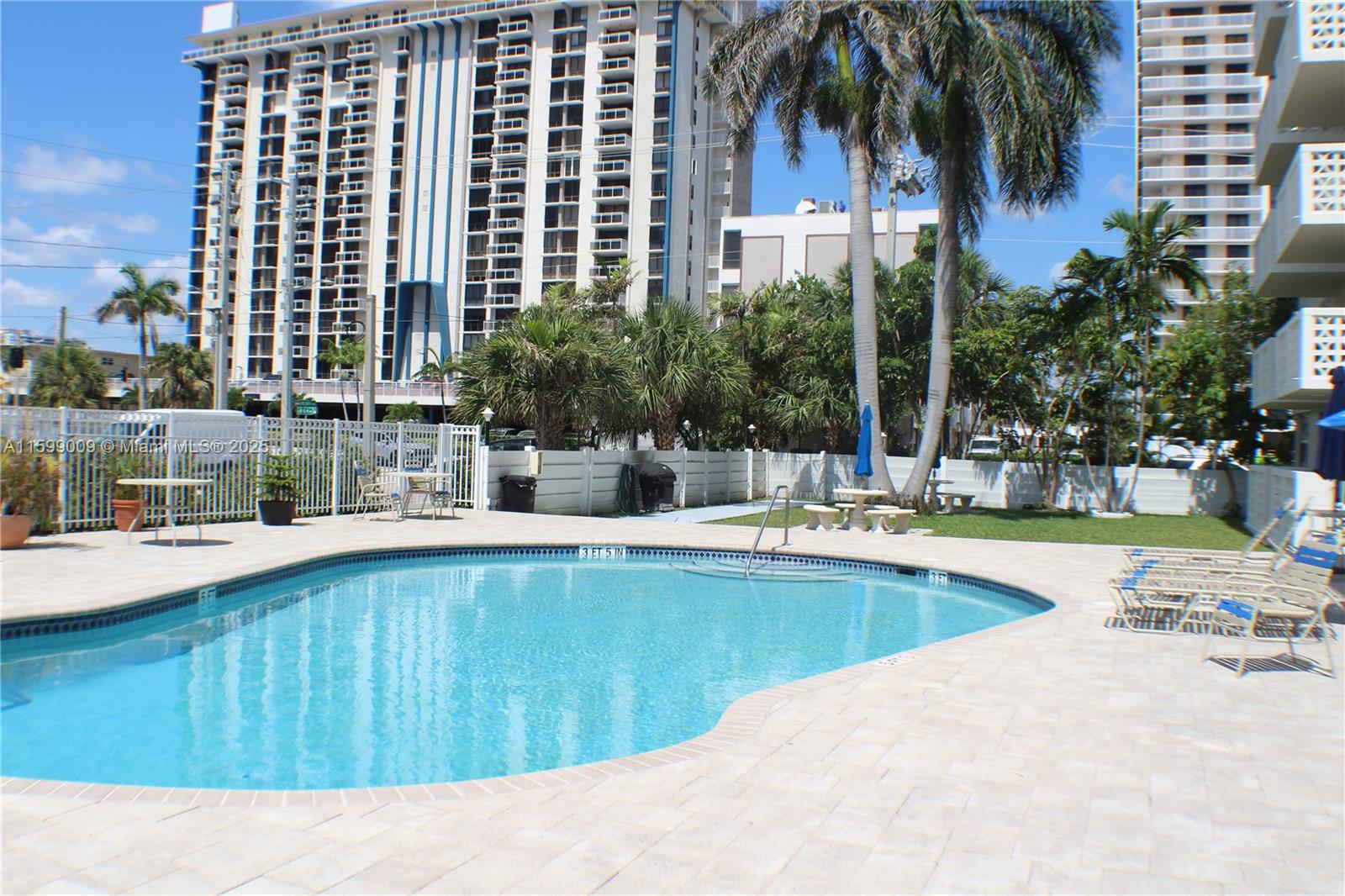 1901 South Ocean Drive, Unit 207 Hollywood, FL 33019 - Photo 28 of 47 a swimming pool with outdoor seating and yard