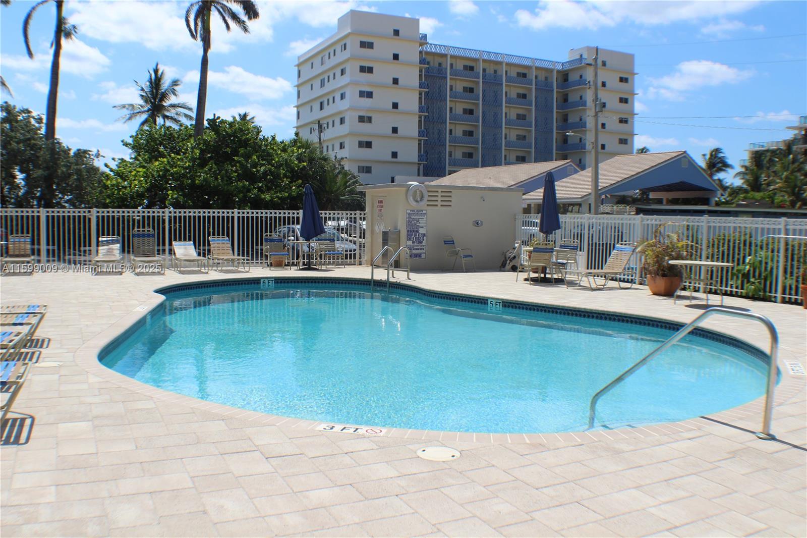 1901 South Ocean Drive, Unit 207 Hollywood, FL 33019 - Photo 46 of 47 a view of a swimming pool with a lounge chairs