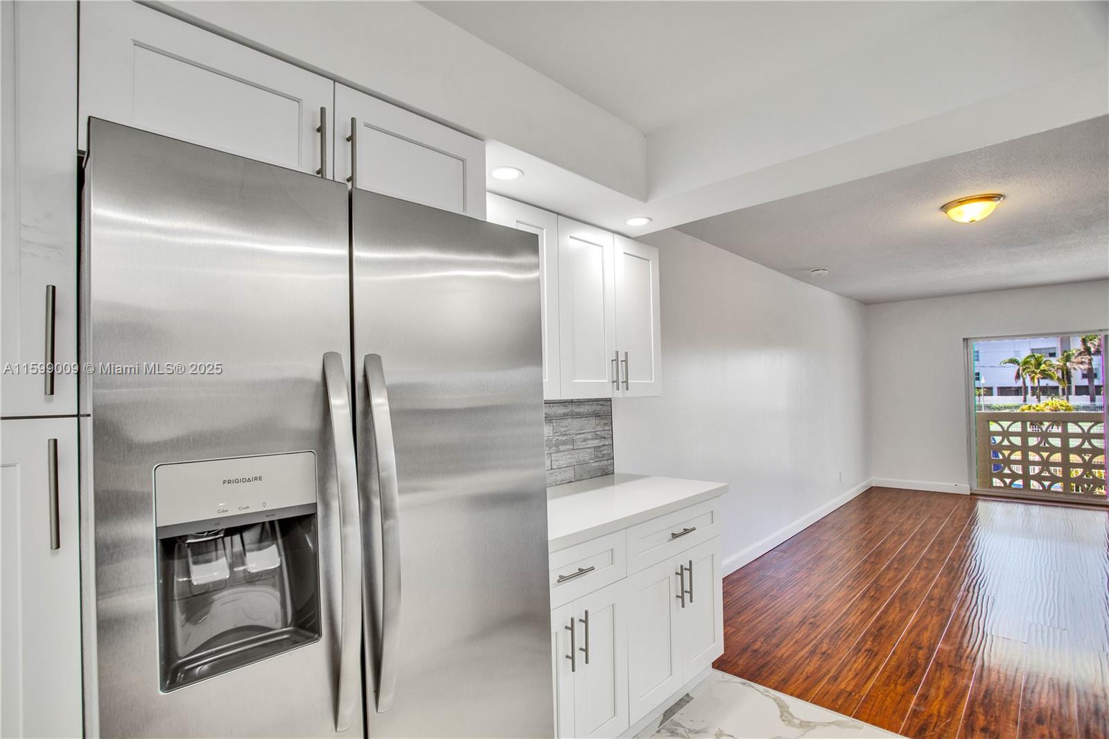 1901 South Ocean Drive, Unit 207 Hollywood, FL 33019 - Photo 9 of 47 a kitchen with a refrigerator and a wooden floor