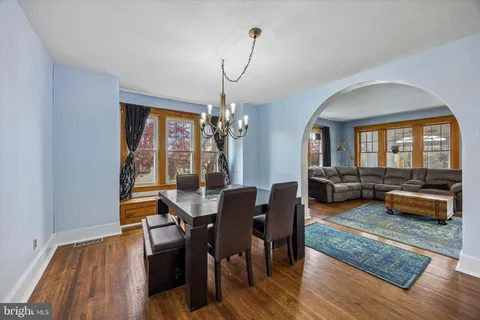 a view of a dining room with a table and chairs