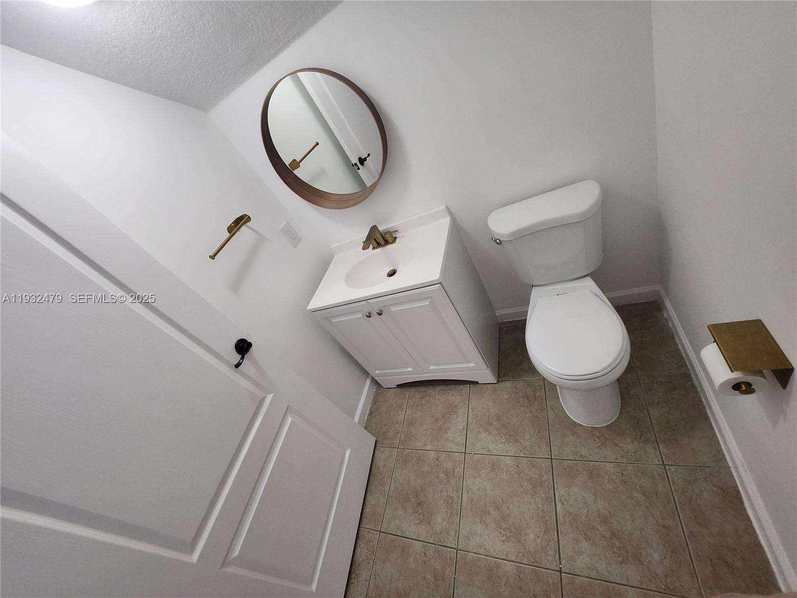 13973 Southwest 276th Way Homestead, FL 33032 - Photo 11 of 43 a bathroom with a toilet and a sink