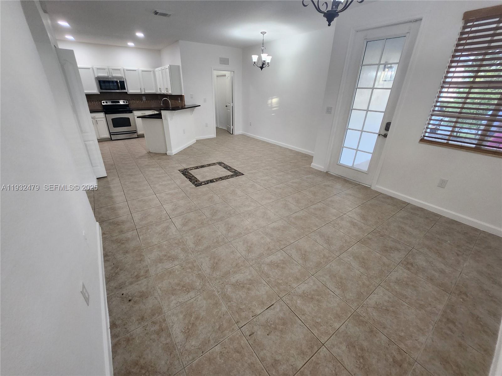 13973 Southwest 276th Way Homestead, FL 33032 - Photo 14 of 43 a view of kitchen with refrigerator sink and microwave