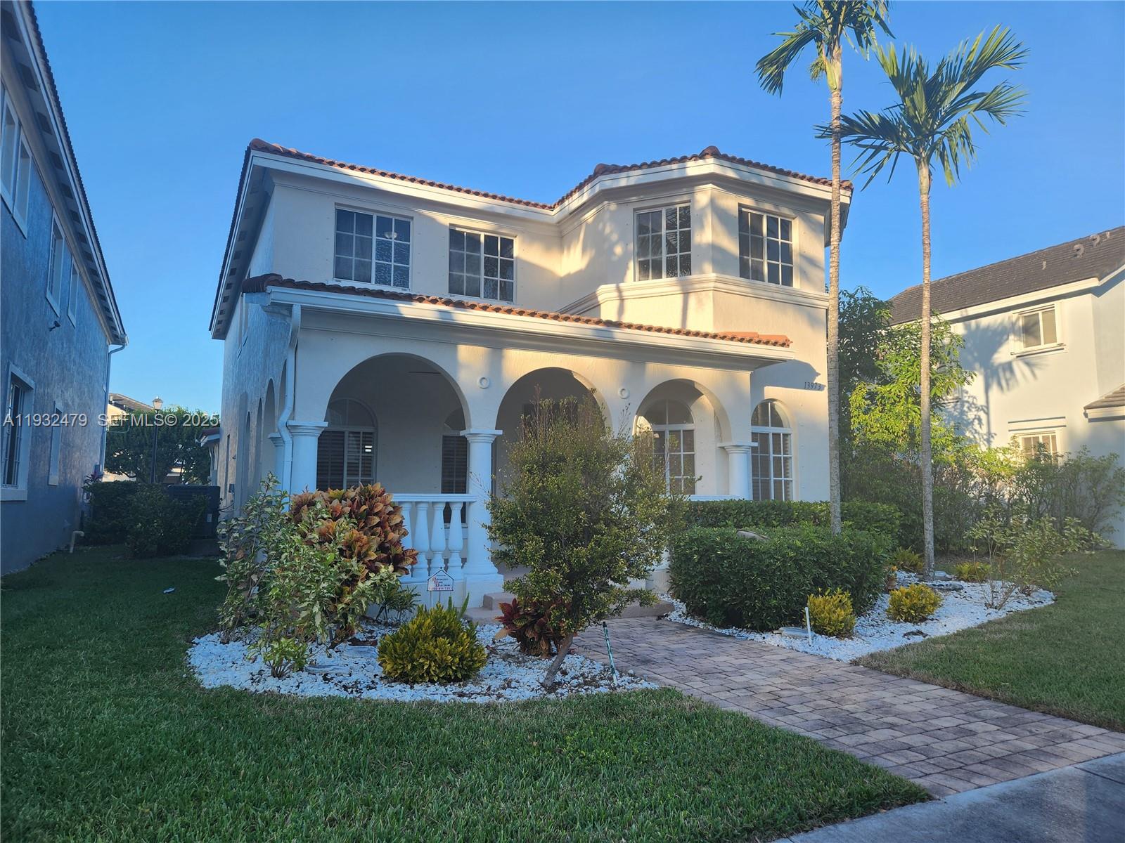 13973 Southwest 276th Way Homestead, FL 33032 - Photo 2 of 43 a front view of a house with a garden