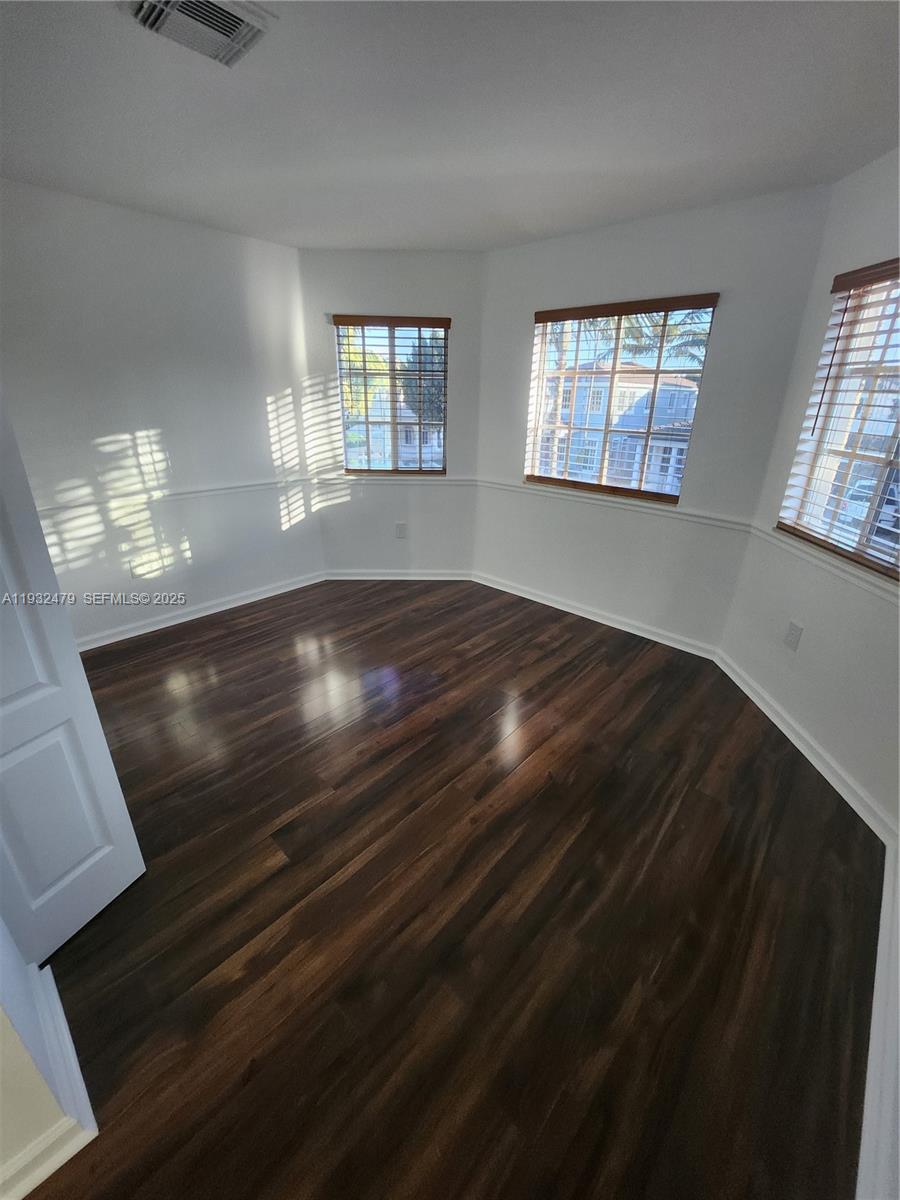 13973 Southwest 276th Way Homestead, FL 33032 - Photo 24 of 43 a view of an empty room with wooden floor and a window