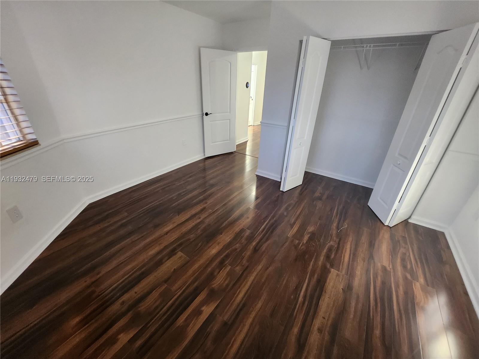 13973 Southwest 276th Way Homestead, FL 33032 - Photo 27 of 43 a view of room with wooden floor