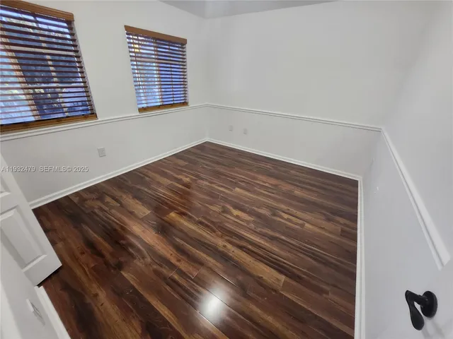 a view of room with wooden floor