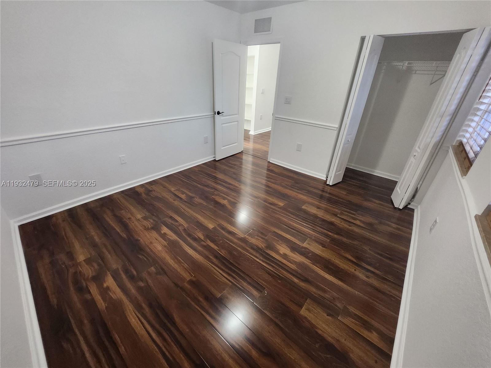 13973 Southwest 276th Way Homestead, FL 33032 - Photo 29 of 43 a view of room with wooden floor