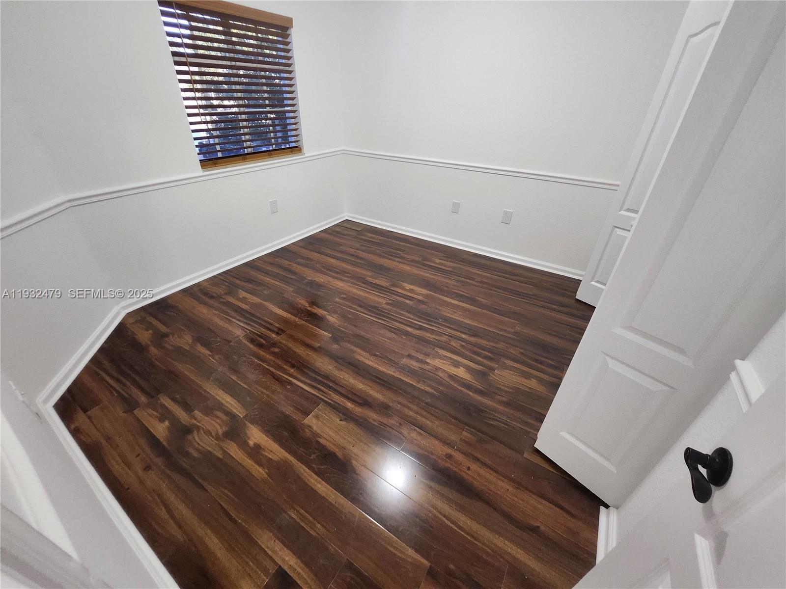 13973 Southwest 276th Way Homestead, FL 33032 - Photo 32 of 43 a view of empty room with wooden floor