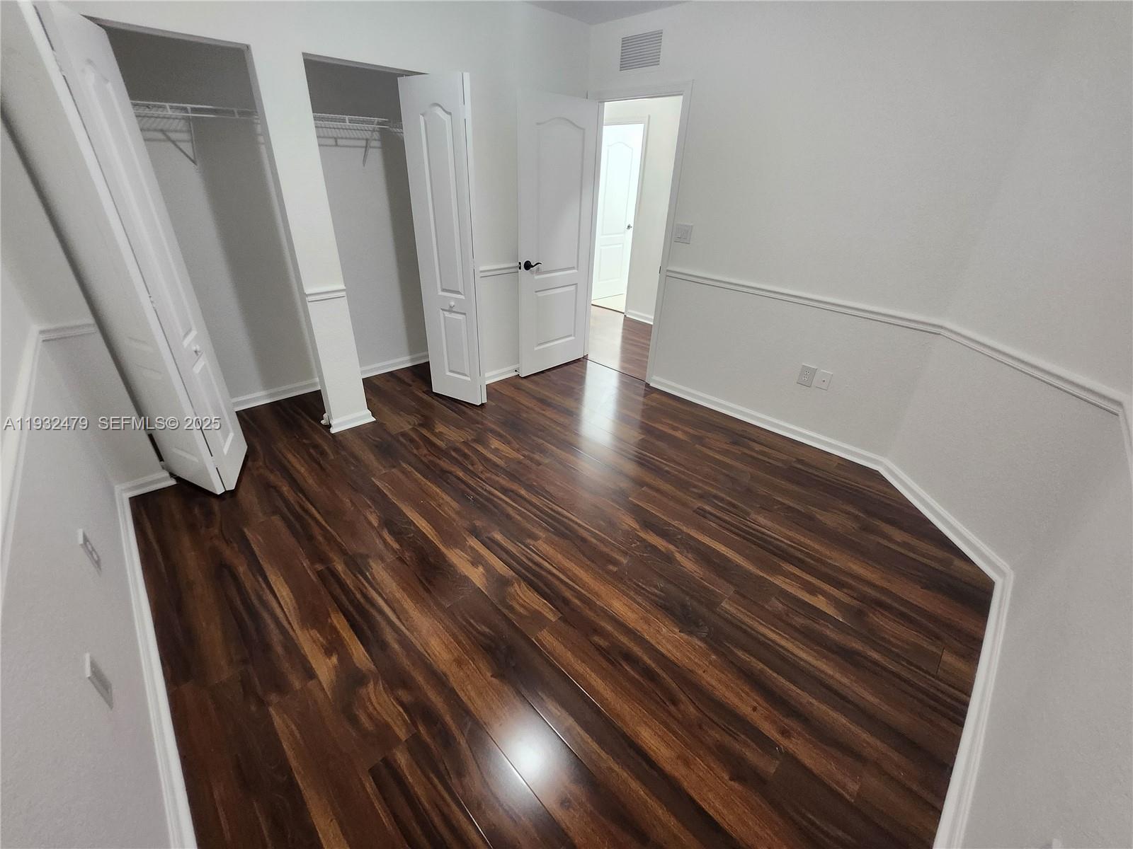 13973 Southwest 276th Way Homestead, FL 33032 - Photo 33 of 43 a view of an empty room with wooden floor and stairs