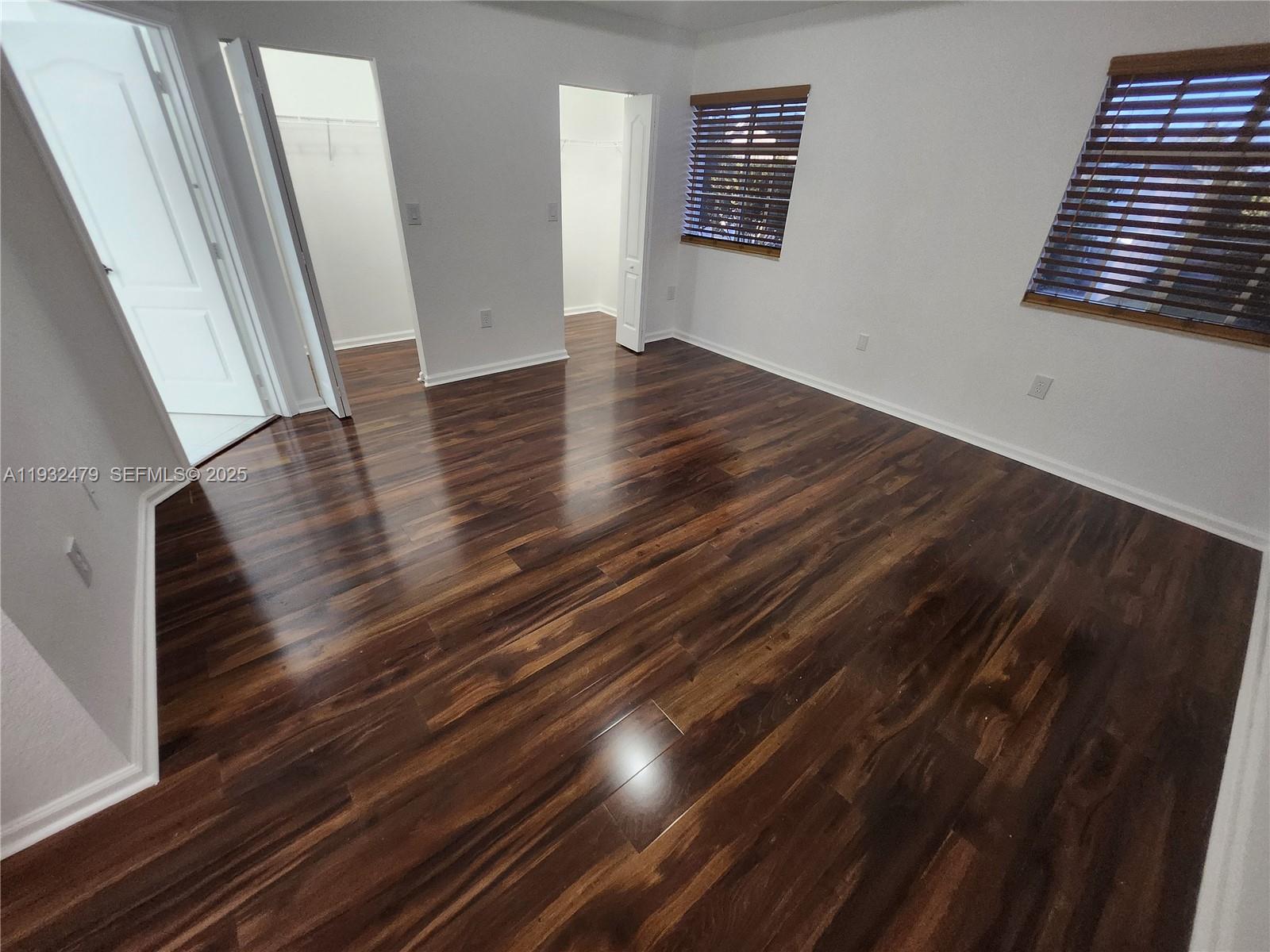 13973 Southwest 276th Way Homestead, FL 33032 - Photo 34 of 43 a view of an empty room with wooden floor and stairs