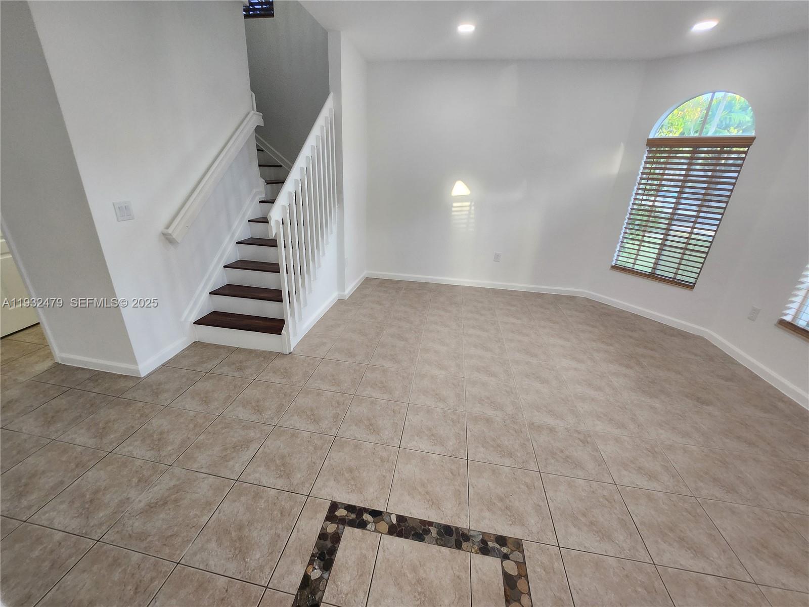 13973 Southwest 276th Way Homestead, FL 33032 - Photo 6 of 43 a view of an empty room with stairs and a window