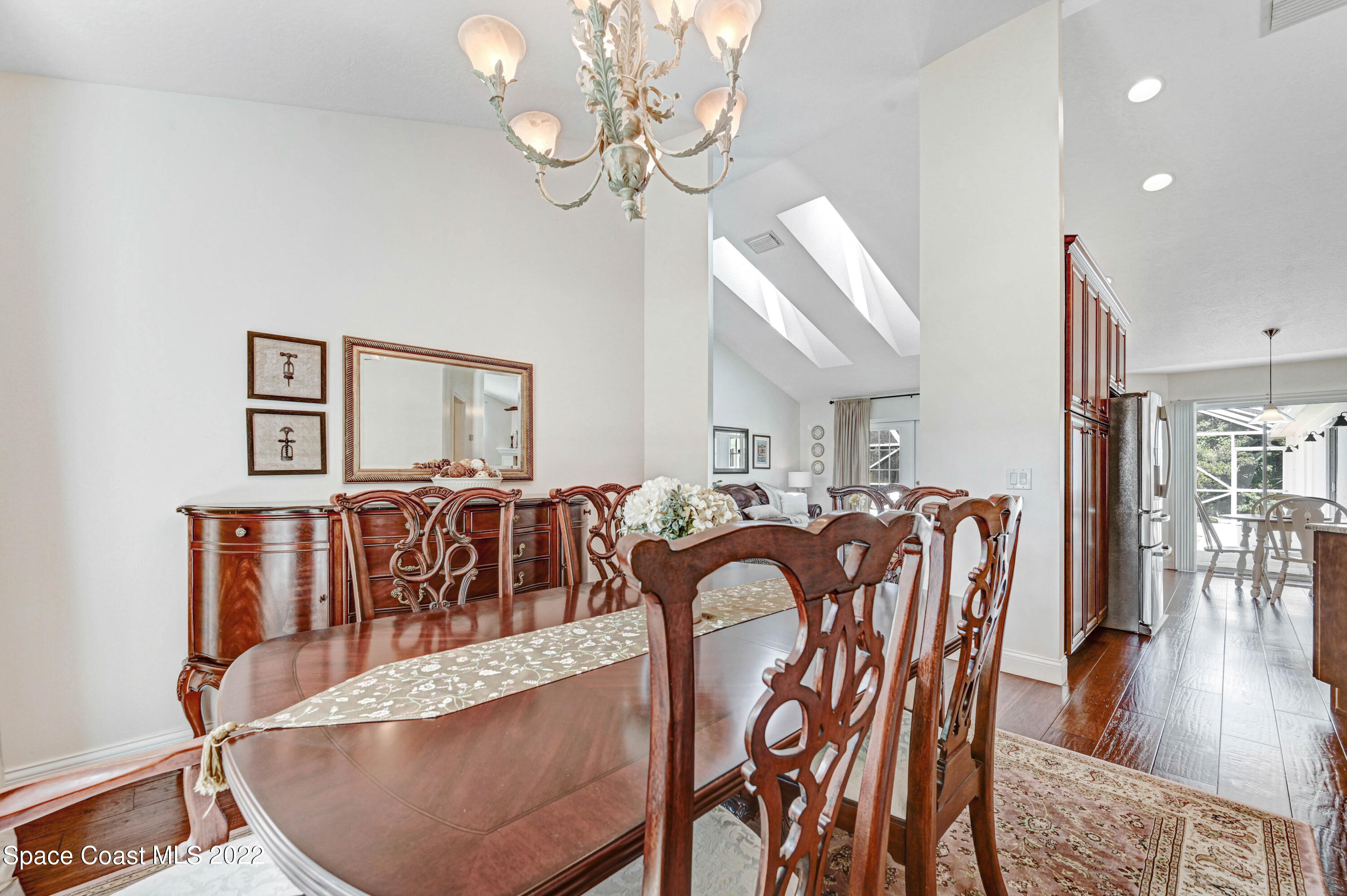 3700 Big Pine Road Melbourne, FL 32934 - Photo 18 of 64 a view of a dining room with furniture wooden floor and chandelier