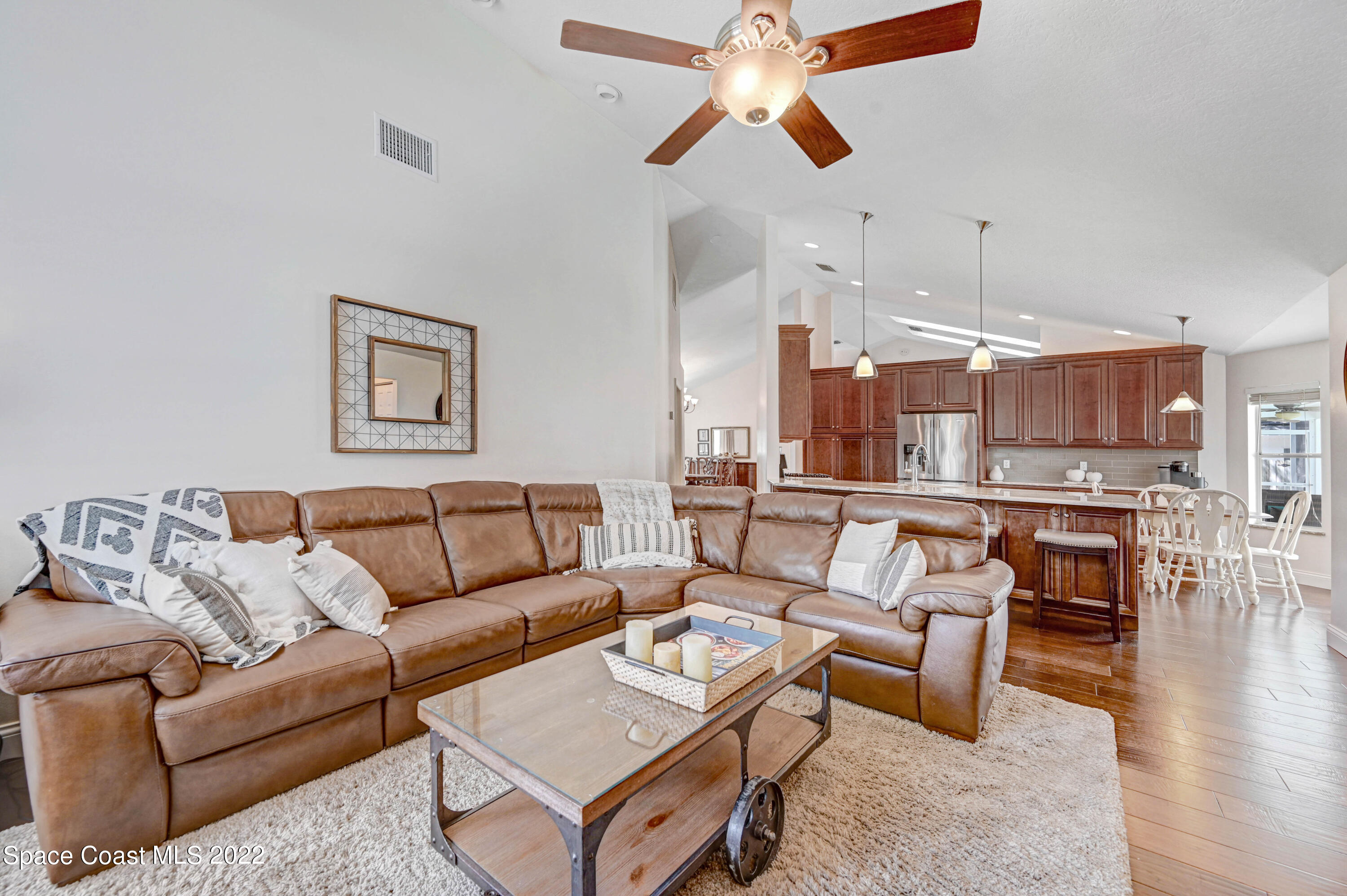 3700 Big Pine Road Melbourne, FL 32934 - Photo 25 of 64 a living room with furniture kitchen view and a wooden floor