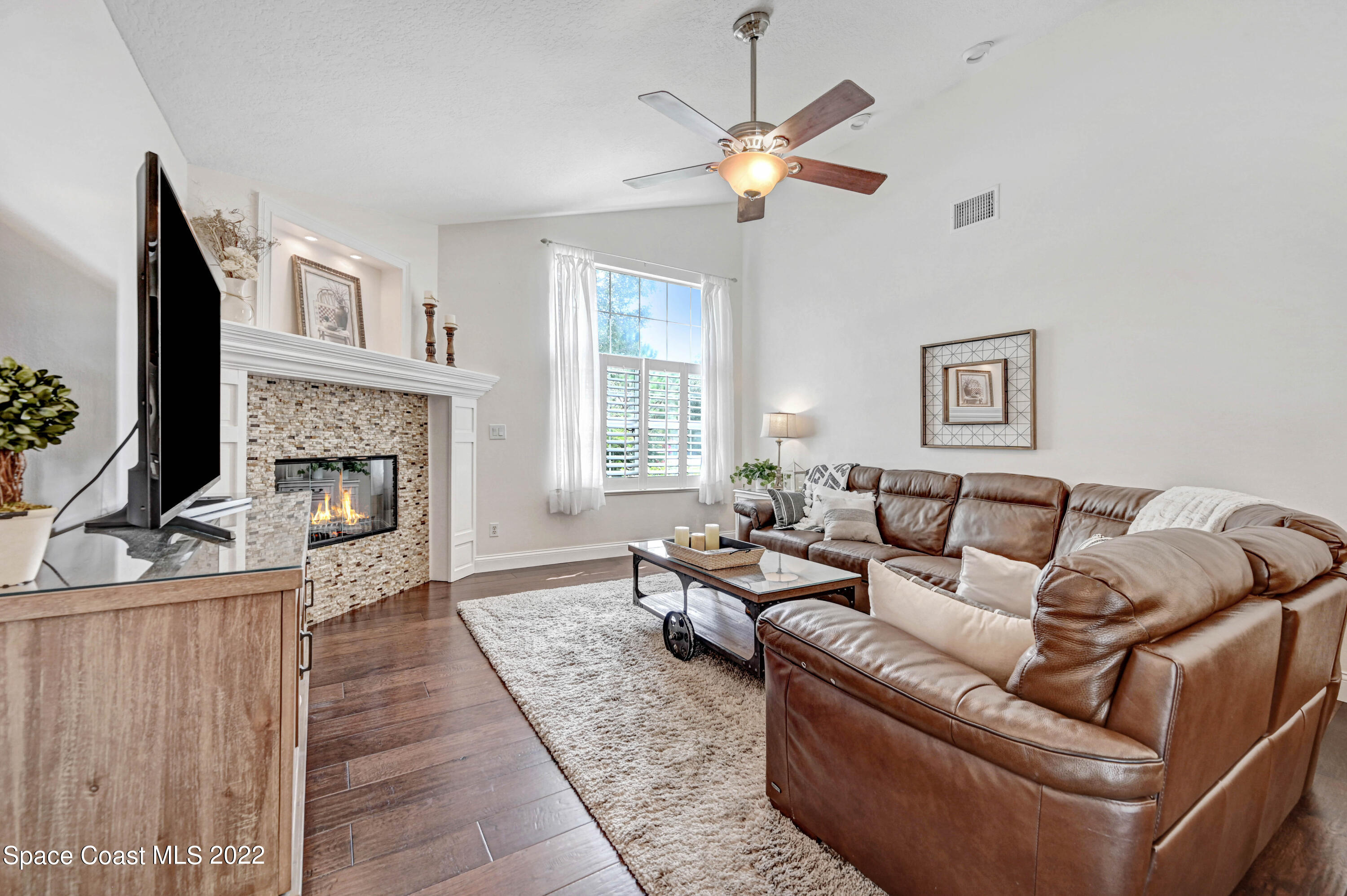 3700 Big Pine Road Melbourne, FL 32934 - Photo 28 of 64 a living room with furniture and a fireplace