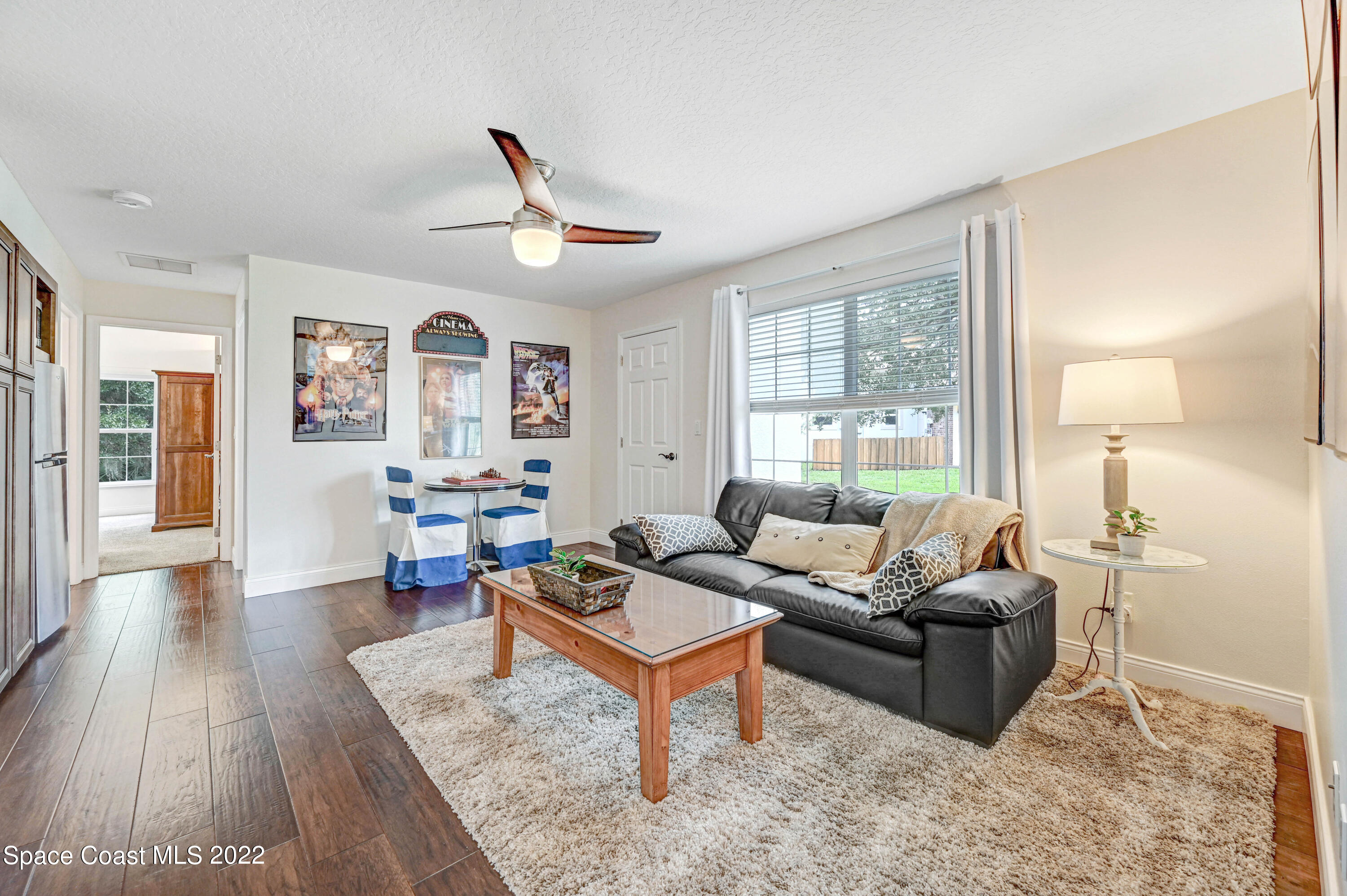 3700 Big Pine Road Melbourne, FL 32934 - Photo 33 of 64 a living room with furniture a wooden floor and a large window