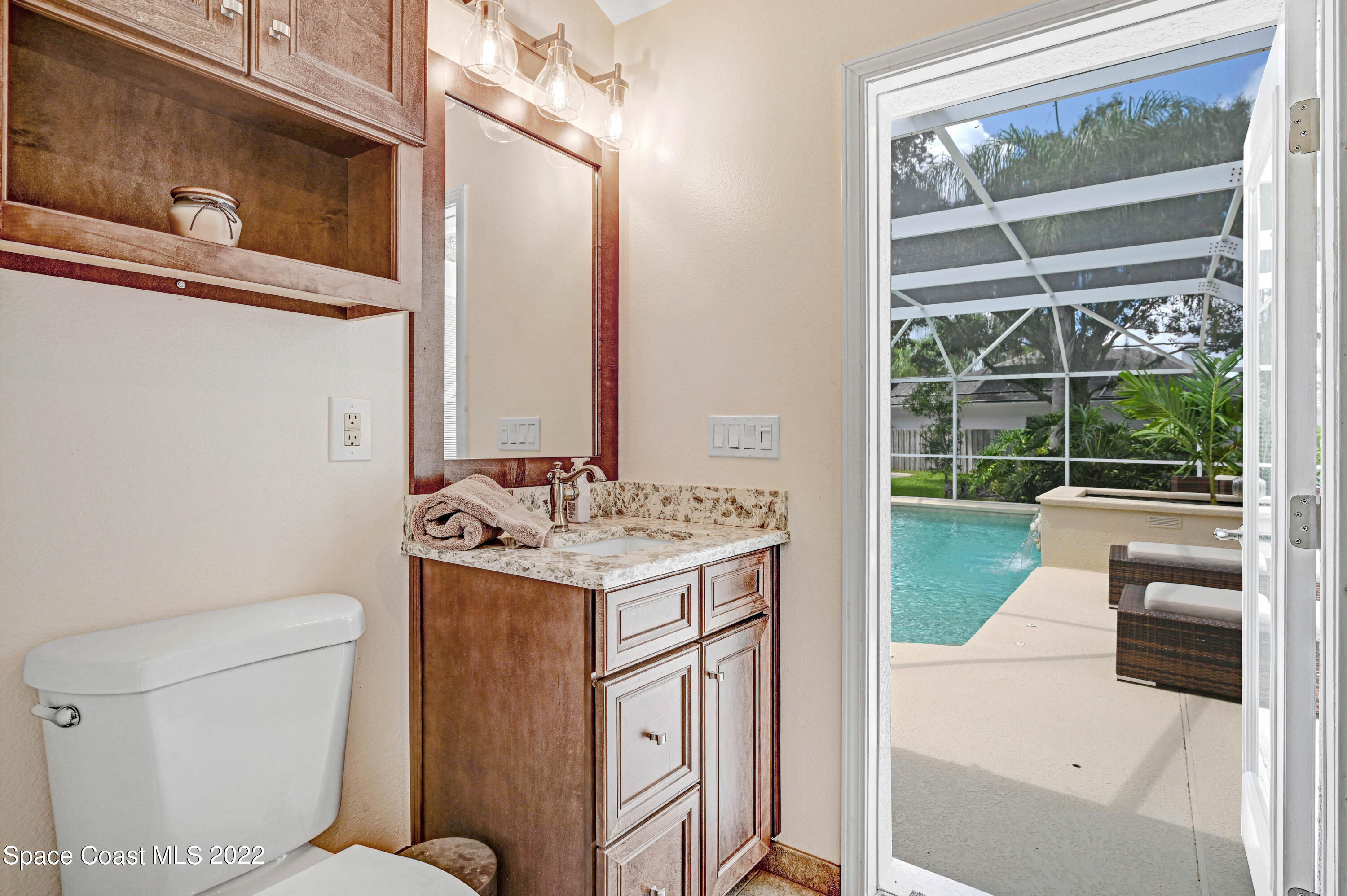 3700 Big Pine Road Melbourne, FL 32934 - Photo 38 of 64 a bathroom with a granite countertop sink and a toilet