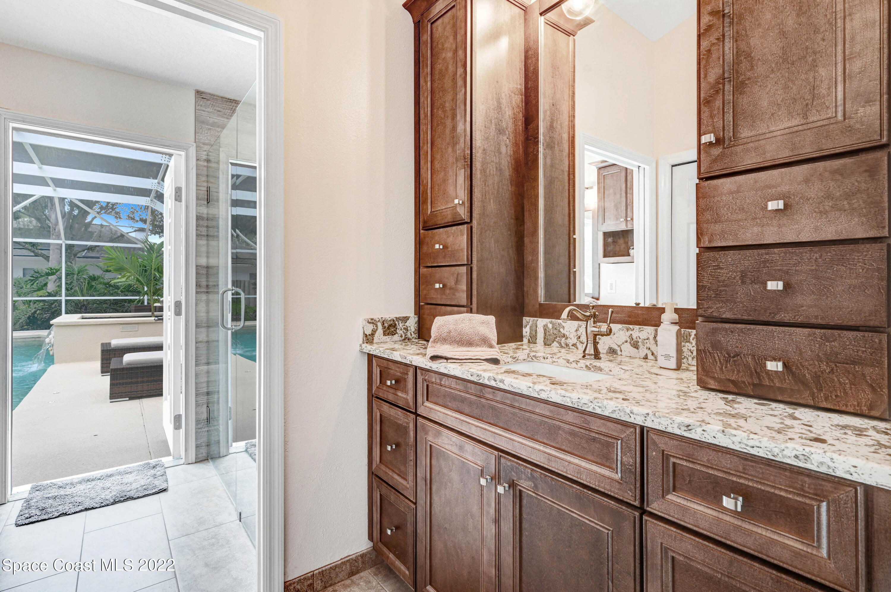 3700 Big Pine Road Melbourne, FL 32934 - Photo 39 of 64 a bathroom with a granite countertop sink and a mirror
