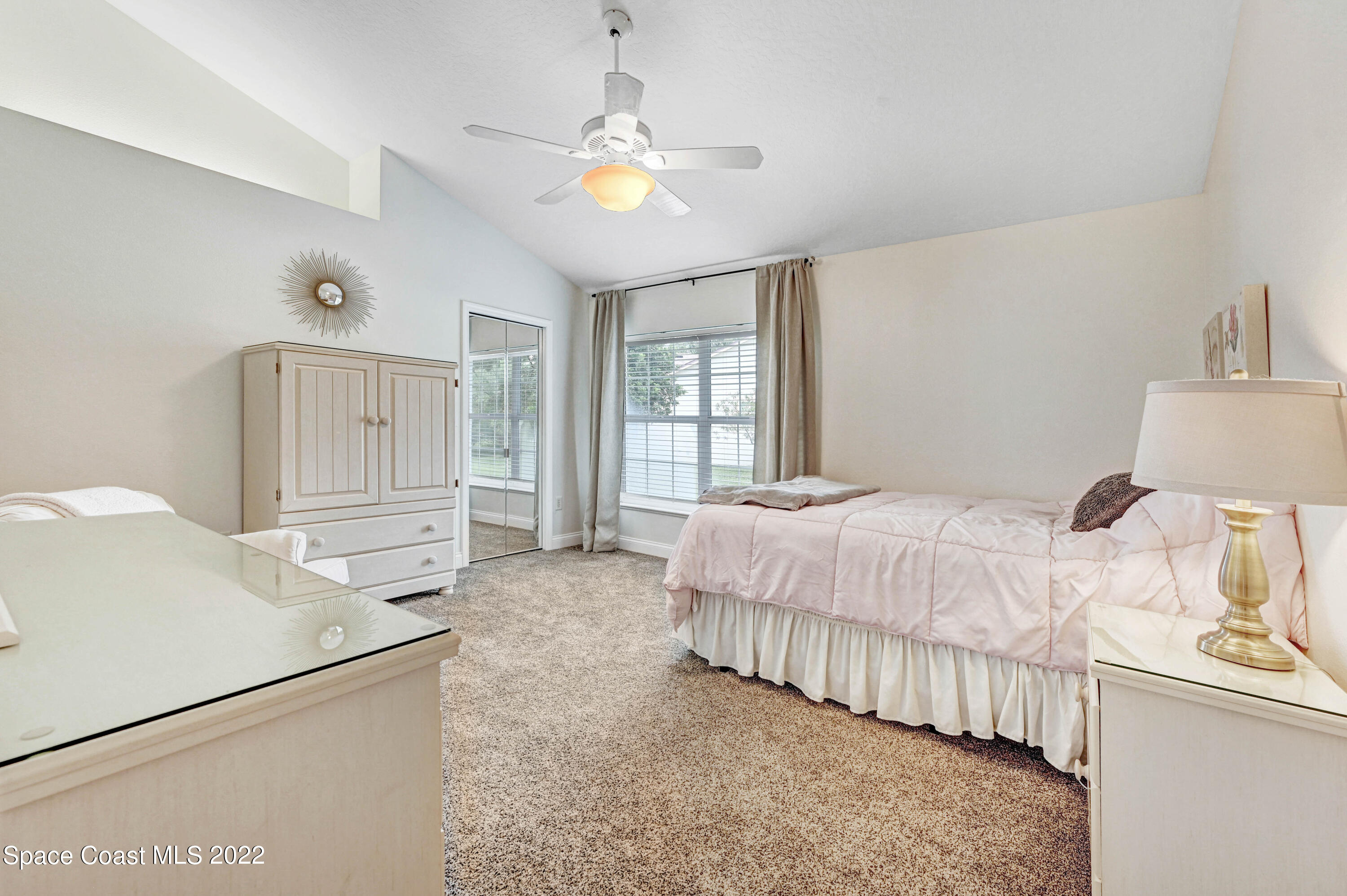 3700 Big Pine Road Melbourne, FL 32934 - Photo 43 of 64 a spacious bedroom with a bed and a window