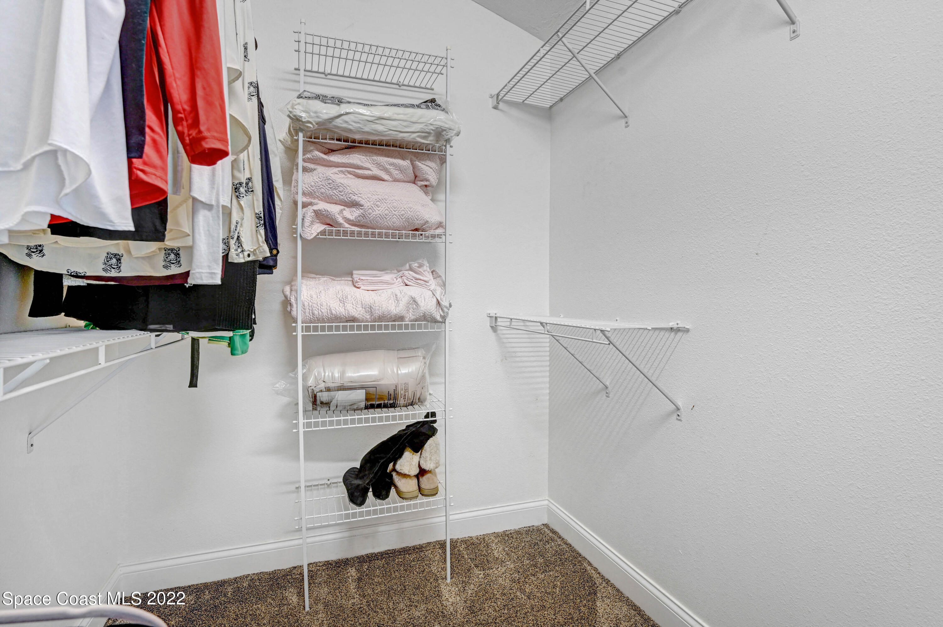 3700 Big Pine Road Melbourne, FL 32934 - Photo 44 of 64 a view of walk in closet with clothes and shoes