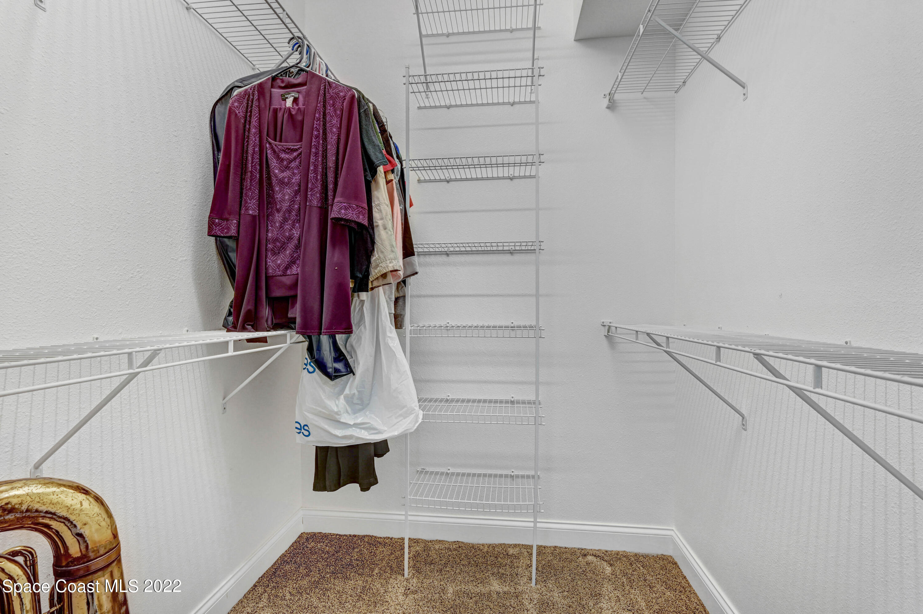 3700 Big Pine Road Melbourne, FL 32934 - Photo 47 of 64 a view of walk in closet with clothes and shoes
